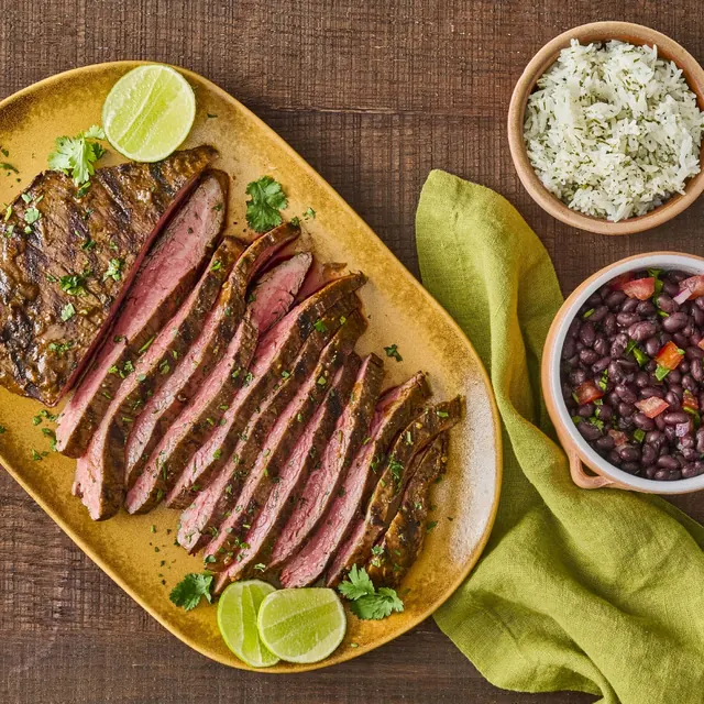 Sliced steak with lime, cilantro and red onion